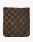 The Clare Vivier Carryall Clutch w/ Tabs is a large flat pouch with alternating brown and black leather squares in a checkerboard pattern, featuring a top left zipper closure and an interior zip pocket for convenient storage.