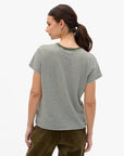 Clare Vivier Classic Tee with OUI graphic in white, styled with brown pants, shown from the back.