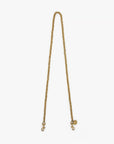 The Clare Vivier Crossbody Strap S25 features a gold rope-chain design with metal clips and a round tag, shown on a white background—ideal for adding stylish flair to your favorite bag.