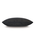 A black Eastern Accents Octa Wool Pillow with a dotted pattern, photographed against a white background in a Scottsdale Arizona bungalow.