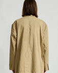 Denimist deconstructed blazer with belt in brown, modeled from the back, casual contemporary womenswear.