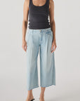 A person wearing the AMO Denim Donna Trouser stands against a plain white background.