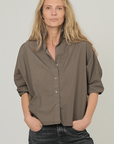 Dark olive Monday12 Daria Shirt in relaxed fit, styled with black jeans; casual, modern look.