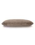 A simple brown cylindrical Adri Faux Fur Pillow isolated on a white background in a Scottsdale, Arizona bungalow by Eastern Accents.