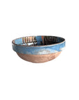 The Cottage Crafted Bowl by Blue Ocean Traders features a matte brown base, blue glazed rim, and colorful abstract patterns inside—ideal as a decorative display against a plain white background.