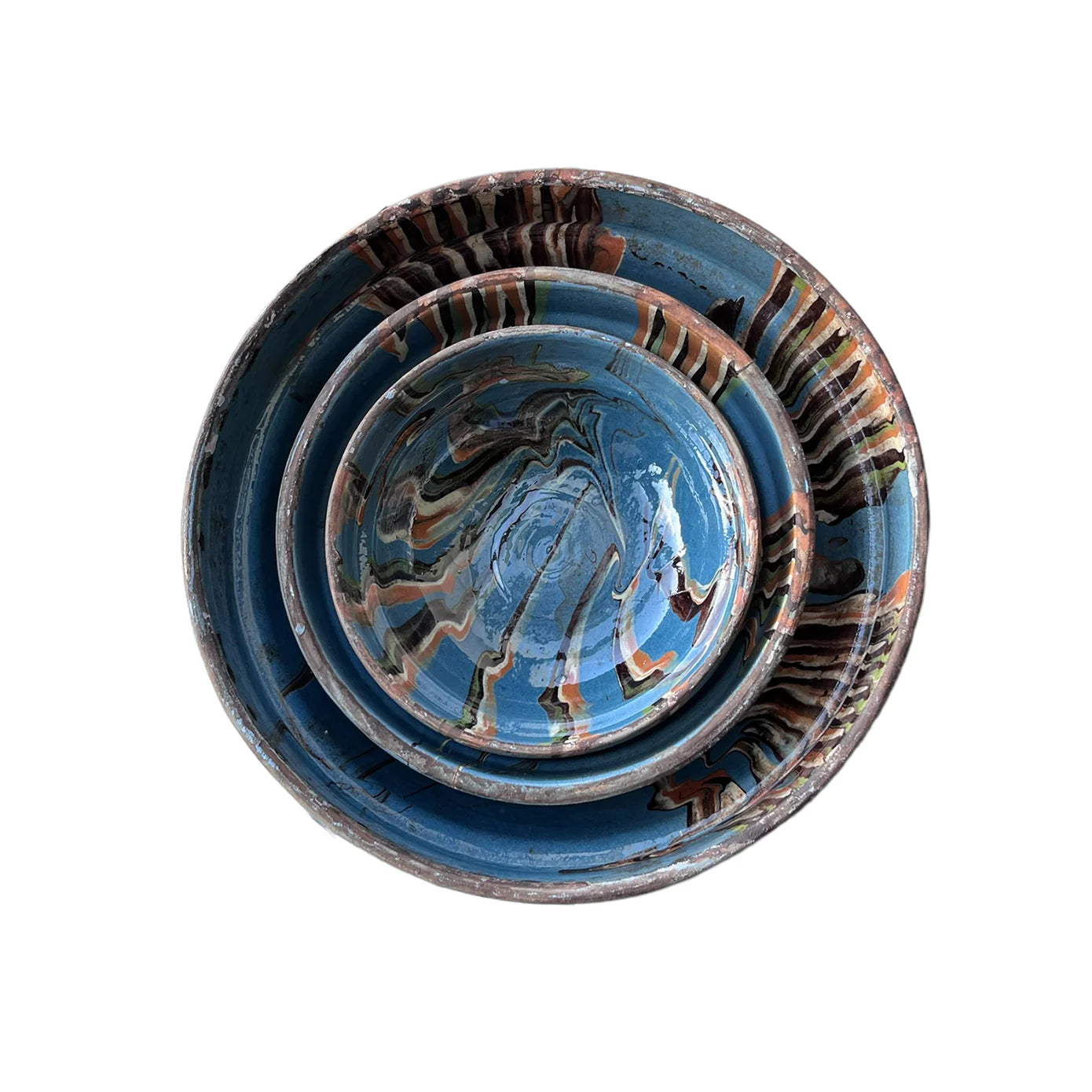 Three Blue Ocean Traders Cottage Crafted Bowls with blue, brown, and white marbled patterns are stacked together, viewed from above against a white background—ideal for decorative displays.