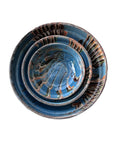 Three Blue Ocean Traders Cottage Crafted Bowls with blue, brown, and white marbled patterns are stacked together, viewed from above against a white background—ideal for decorative displays.