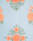 The Bipin Tangerine Quilt by John Robshaw features blue and white vertical stripes with orange floral patterns and green leaves, perfect for coordinating with other patterns or creating eye-catching cotton voile looks.