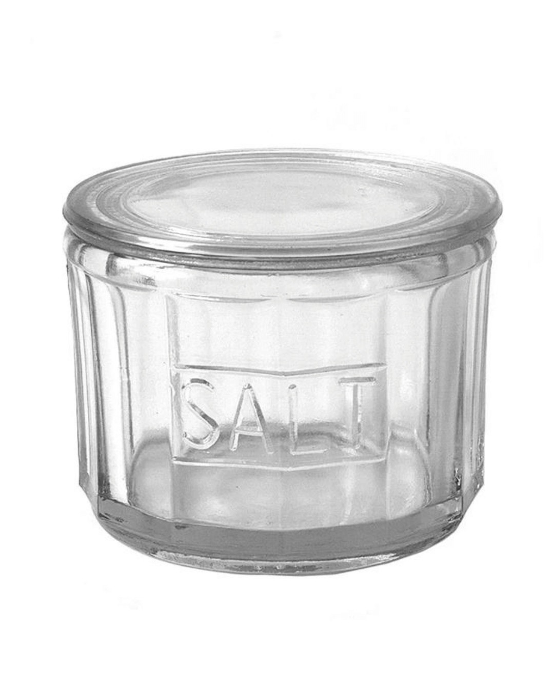 The DA3024 Glass Salt Cellar by Creative Co-op features a clear pressed glass jar with vertical ridges on the sides and a matching lid. The word "SALT" is elegantly embossed on the front, making it perfect for showcasing your specialty salts on the kitchen counter.