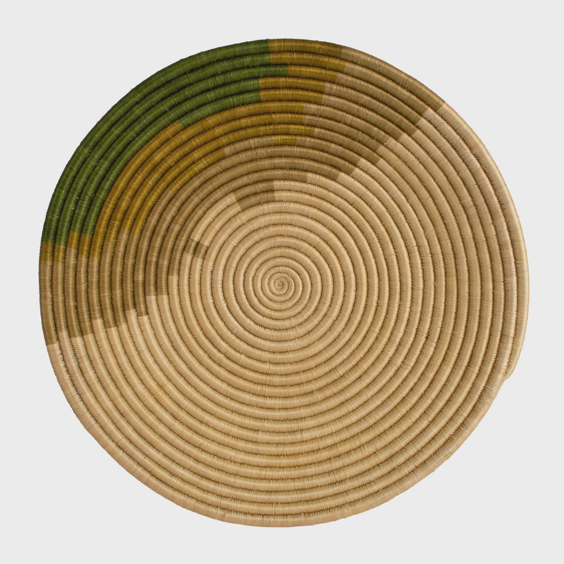 A Restorative Woven Bowl 21" Moss featuring concentric circles in various shades of green and beige, isolated on a white background, perfect for a Scottsdale Arizona bungalow.