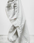 The Out of Sight Poplin Jump Pant by Free City (sparrow, LLC) is shown in light gray Japanese poplin with elastic waist and cuffs, set against a plain background. "freecitysupershop" logo appears at the bottom of the image.