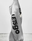 A gray sweatshirt with bold black "LOSES" lettering hangs on a plain wall, "art+commerce" in the bottom left. Pair it with FreeCity Letsgo BleachOut Sweatpant by Free City (sparrow, LLC) for a cool, effortless style.