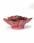 The Dewberry Camellia by Chive Ceramics (thru Faire) is a ceramic flower wall art bowl with layered petals, glazed in deep pink and red hues with brownish edges—a striking statement piece for any room.