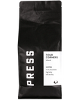 A black bag of Jeff's Antiques Press Coffee 5lb, labeled "Four Corners blend," features tasting notes of milk chocolate, big body, and low acidity on a white section of the packaging.