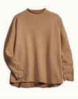The EFFIE L/S Capelet by Frank & Eileen is a camel-colored, long-sleeve sweater in triple fleece, featuring a relaxed fit and crew neckline. Perfect for winter warmth, it’s shown laid flat on a white background.