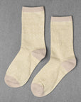 Unified Glitter Socks in light yellow feature beige toes, heels, and cuffs, shown on a gray background.
