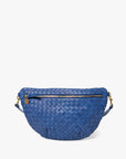 The Clare Vivier Grande Fanny S26 is a blue handwoven leather crossbody bag with a curved shape, gold zipper and hardware, plus a small round charm on the zipper pull.