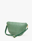 The Grande Fanny S25 by Clare Vivier is a stylish green and white checkered shoulder bag crafted from handwoven leather. With its curved shape, gold hardware, and adjustable green strap, it doubles as a perfect crossbody accessory. Set against a plain white background, it truly stands out.