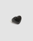 The Grande Heart Ring / Black by Clare Vivier is a glossy black resin heart-shaped ring, ideal for love jewelry fans, shown on a simple light gray background.