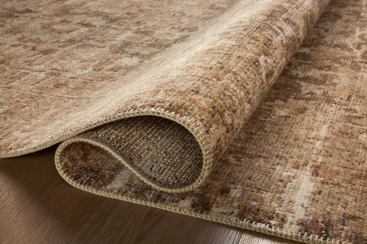 A close-up image of a Loloi Rugs Bark / Multi Rug on a wooden floor, showcasing its textured weave and muted, earthy tones in Arizona bungalow style.