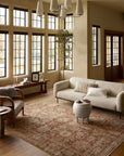 Elegant bungalow living room featuring large windows, a beige sofa, a unique round coffee table, and a Loloi Rugs Brick / Multi Rug, accented by calm, natural lighting and neutral walls in Scottsdale Arizona.