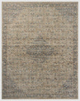 A detailed, vintage-style Sage / Navy Rug in muted beige, blue, and gray tones featuring intricate traditional patterns typical of Scottsdale, Arizona, with a distressed finish. The Loloi Rugs's edges are bounded, accentuating its rectangular shape.