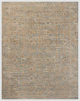 A textured Ocean / Sand Rug displaying a faded, intricate pattern with shades of blue, beige, and brown, resembling a vintage style typical of a Scottsdale Arizona bungalow by Loloi Rugs.