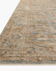 Close-up of a section of a Ocean / Sand Rug with a subtle, faded floral pattern in muted blue and beige tones, typical of a Scottsdale, Arizona bungalow, showing detail of the weave and edges by Loloi Rugs.