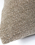 Close-up of the corner of the POM POM Hendrick Body Pillow, featuring a textured beige handwoven cover. The weave pattern stands out against a white background, highlighting its natural fiber look.