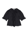 The Henri Top by DOEN is a black, short-sleeved, Edwardian-inspired blouse featuring puffed sleeves, a ruffled lace-trimmed collar and front, and elastic smocked cuffs. Made from lightweight organic cotton voile that's slightly sheer.