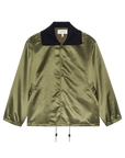 The Great Inc. Satin Coach's Jacket features shiny olive green satin, a black oversized rib collar, side pockets, elastic cuffs, and adjustable hem drawstrings for a classic vintage look, displayed on a white background.