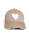 Introducing the KR Imperfect Heart Hat by Kerri Rosenthal, a light brown cap with a white heart emblem. Set against a plain white backdrop, this exclusive collectible is an irresistible addition to any accessory collection.