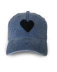 The KR Imperfect Heart Hat by Kerri Rosenthal is a faded blue, 100% cotton hat with a black heart patch on the front, displayed on a white background.