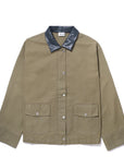 The Ripley by Kule is an olive green chore coat with a black leather collar, snap button front, and two large front pockets. Made from a durable cotton-linen blend, it combines style and functionality.