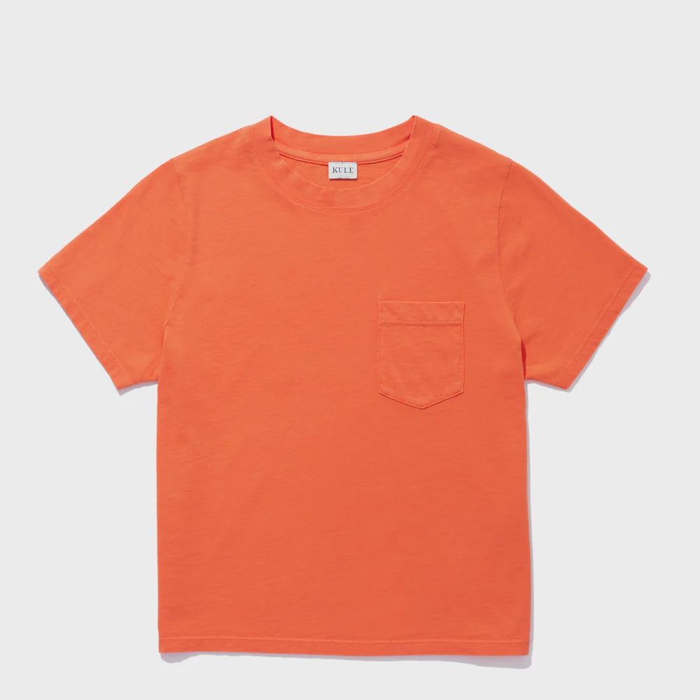 The Kule Wynn Baby Tee, shown on a white background, is an orange 100% cotton top with garment-dye color, short sleeves, a crew neckline, and a small chest pocket.