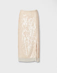 The Rag & Bone kali skirt is a knee-length, light beige sequin midi with a subtle front slit and sheer hem detail, perfect for parties. Shown against a plain white background.
