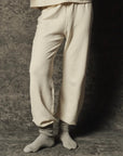 The Great Inc. Dance Pant in gray with matching socks, waist-down view against a textured gray background.