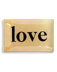 A vintage-style Tray 5.5" x 8.5" golden keychain with the word "love" written in black cursive letters on a cream background, enclosed in a glossy rectangular frame, perfect for a Scottsdale Arizona souvenir. (Ben's Garden)