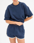 Navy cotton Le Jogging Short with elastic waist and side pockets by Clare Vivier, styled with a matching top.