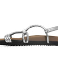 The Roam Linky Sandal by Roam features silver straps, a contoured footbed, flat tan base, and a black ridged sole made of sustainable BIO EVA, shown in profile view facing left.