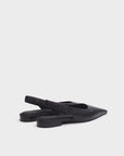 The Rag & Bone mercer slingback flat features black pointed-toe leather, low heels, elastic ruched straps, and a cushioned footbed, shown on a plain light background.