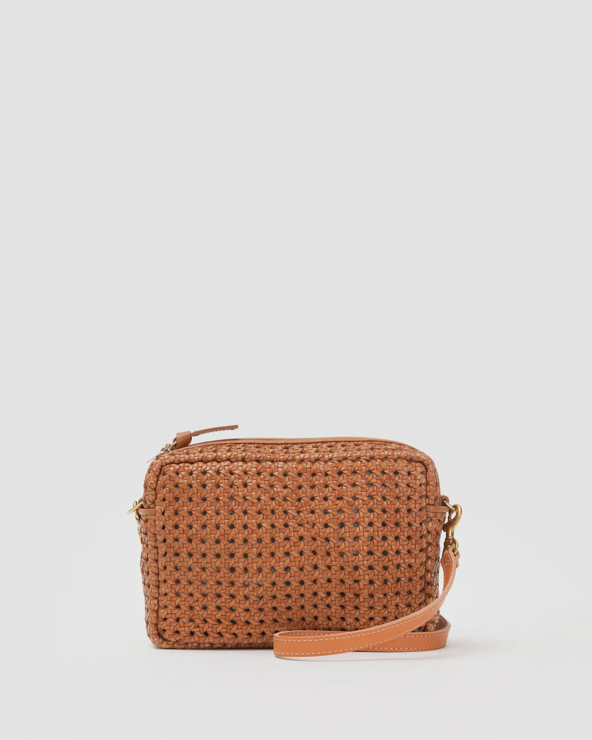 A small handwoven brown Clare Vivier Midi Sac with a zip top and a thin leather strap, displayed against an isolated white background.