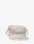 The Clare Vivier Midi Sac S25, a small handwoven leather crossbody bag with a silver metallic texture, gold hardware, and a matching silver strap, is displayed against a plain white background.