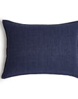 The Montauk Big Pillow 28x36 by POM POM is a rectangular, dark blue pillow made from heavyweight linen with a plain texture, shown against a white background.