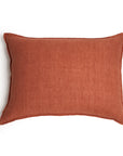 The Montauk Big Pillow 28x36 by POM POM is a rectangular, rust-colored linen pillow with a soft texture and zipper closures, shown against a white background.