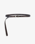 The Janessa Leone Myra DW Belt is crafted from dark brown regenerative leather and finished with artisan silver hardware. It’s shown flat, with one end through the buckle and the other end trailing.