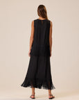 Natalie Martin Anita Skirt with fringe hem and side slit, shown from the back, styled with black sandals.