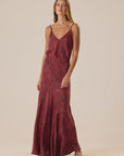 Red patterned Natalie Martin Heath Cami maxi dress with thin straps, shown on model standing forward.
