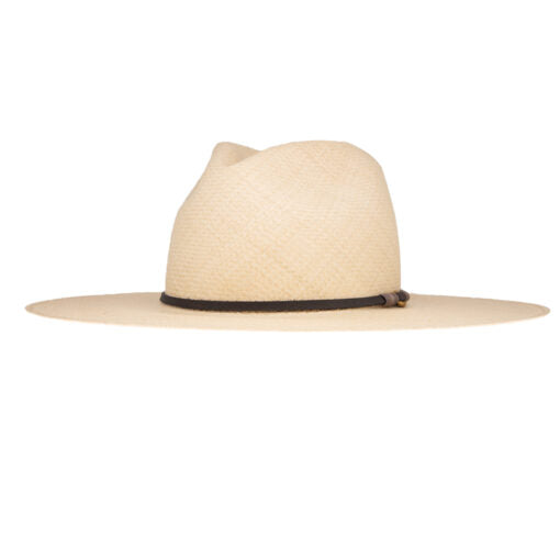 A side view of a beige, wide-brimmed Ninakuru Theo hat with a black ribbon around the crown, reminiscent of Scottsdale Arizona style, isolated on a white background.
