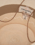 Inside view of a Luna hat by Ninakuru showing the brand label stitched to the beige fabric with an adjustable drawstring visible.